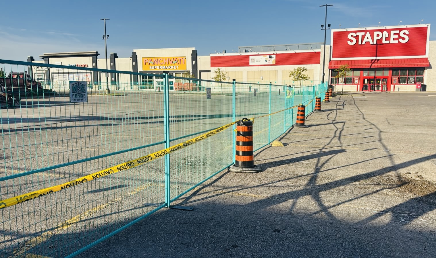 Temporary fencing installed around a commercial parking area