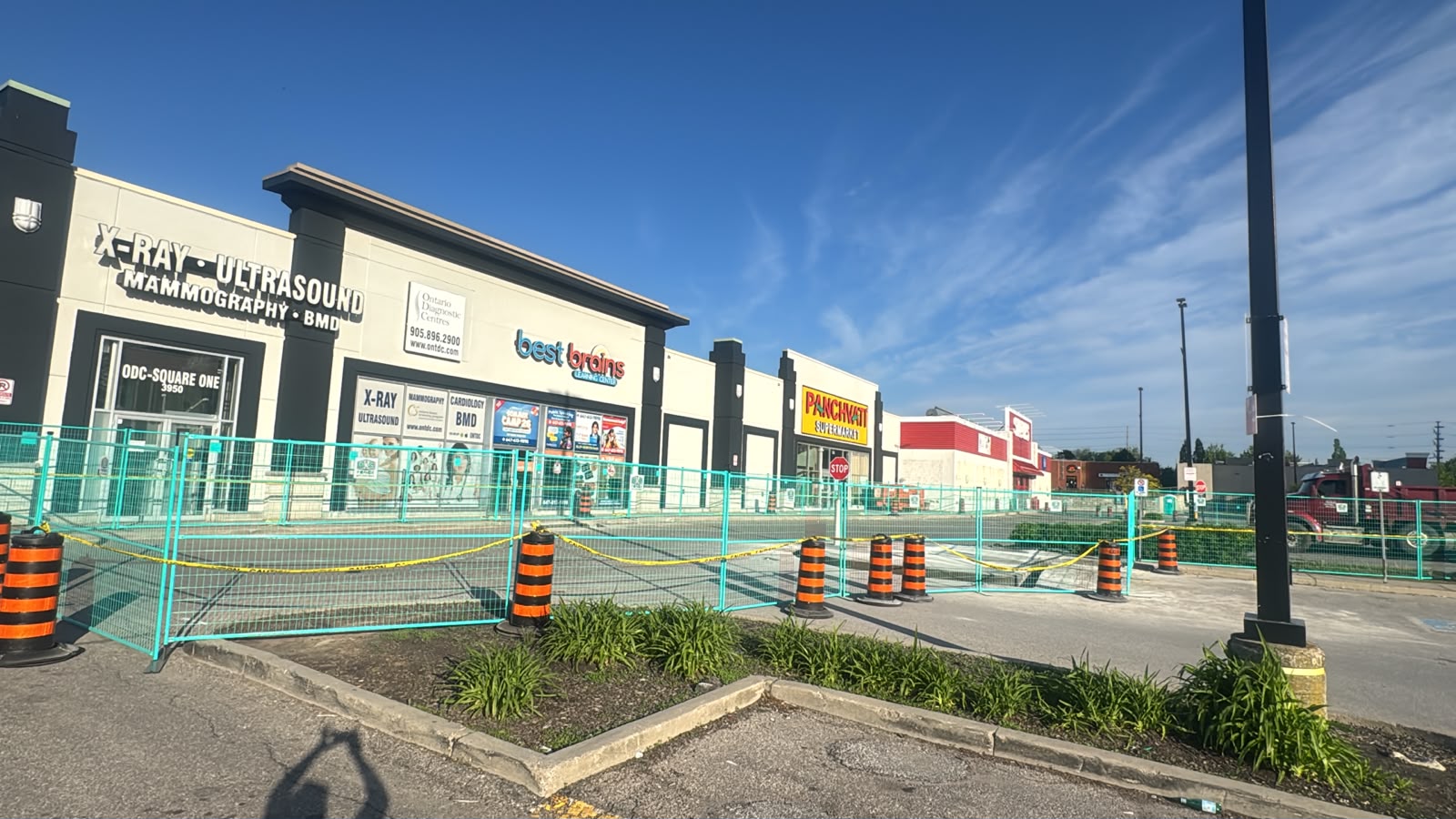Temporary fencing installed around a commercial storefront work area